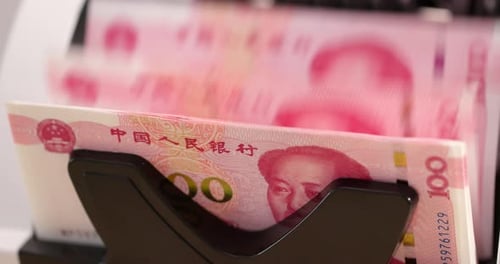 Currency Counter Counting Stacks of Renminbi Notes