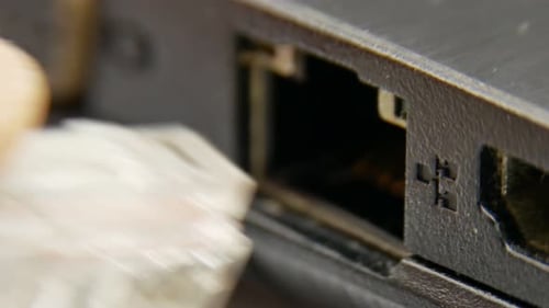 Ethernet Cable Being Plugged Into Laptop Port