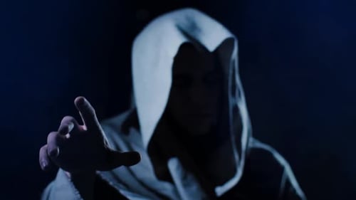 Mysterious Hooded Figure Reaching Out in the Darkness