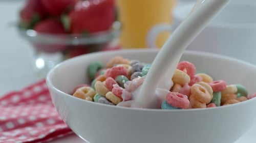 Pouring Milk on Cereal for a Delicious Breakfast