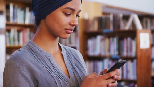 Woman Using Smartphone in Library Close Up