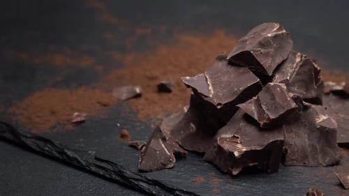 Dark Chocolate Chunks with Cocoa Powder on Slate