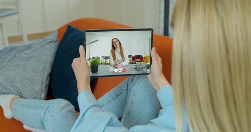 Woman Relaxing on Couch, Video Calling on Tablet