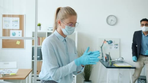 Office Employees Using Hand Sanitizer and Talking During Corona Virus Pandemic