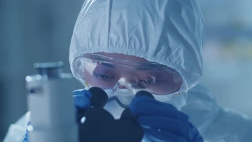 Scientist Works with Microscope in Lab