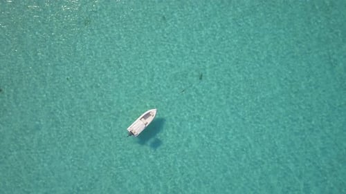 Aerial drone view of a fishing motor boat in the Bahamas, Caribbean.