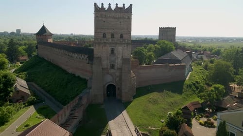 Drone Flies Over Small Medieval Castle on Mountain in Small European City at Cloudy Autumn Day
