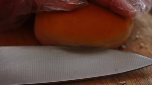 Golden Brioche Bun Being Cut in Half