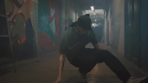Man Breakdancing in Urban Graffiti Tunnel