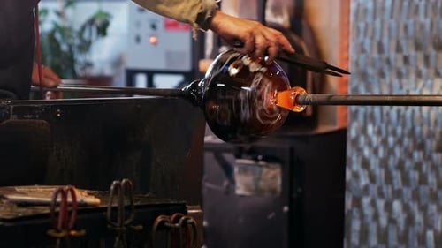 Glass Blower Shaping Molten Glass Sphere