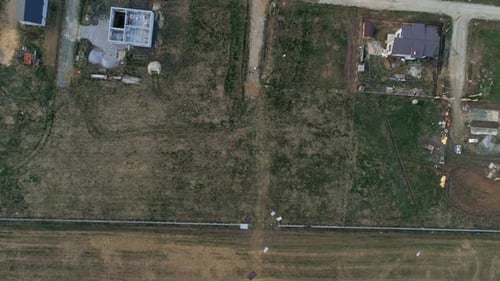 Top down aerial view of free plot for construction in a cottage village