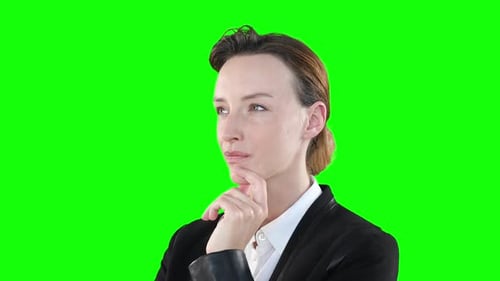 Profile of a Caucasian woman thinking on green background