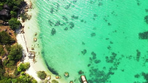 Paradise exotic beach with white sand and beautiful cliffs washed by clear turquoise lagoon with cor