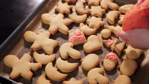 Unrecognizable Woman Decorates Cookies with Pink Icing