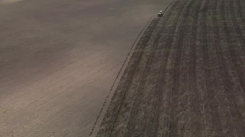 Tractor Working in a Brown Rural Field