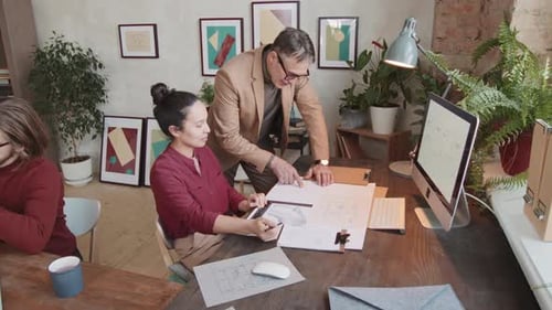 Architects Working On New Project In Stylish Office