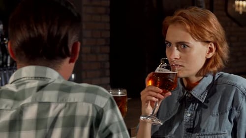 Beautiful Woman Looking Surprised While Talking To a Man at the Bar
