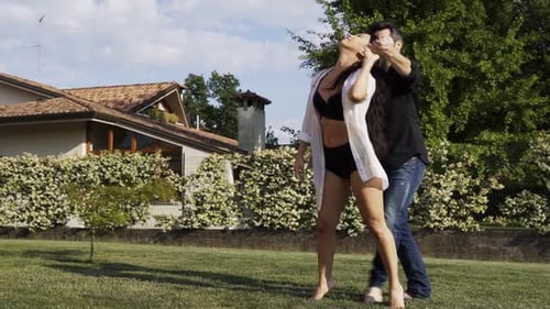 Modern dancers practicing performance in summer garden