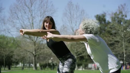 Old and Young Women Doing Forward Bend