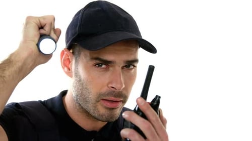 Man Communicating with a Walkie Talkie and Flashlight