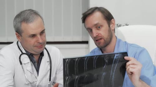 Doctors Reviewing X-Ray in Medical Setting