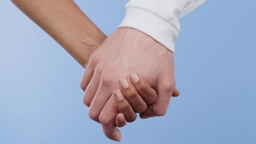 Couple Holding Hands in Close-Up Shot