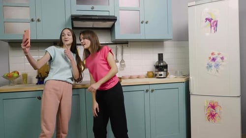 Young Women Preparing Food Together in Kitchen