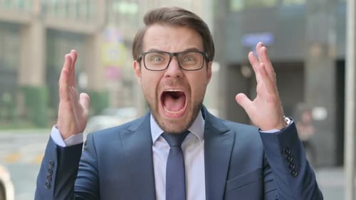 Man in Suit Yelling Outdoors in Urban Setting
