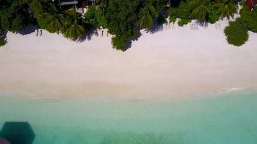 Aerial drone texture of coastline beach by blue water with sand background