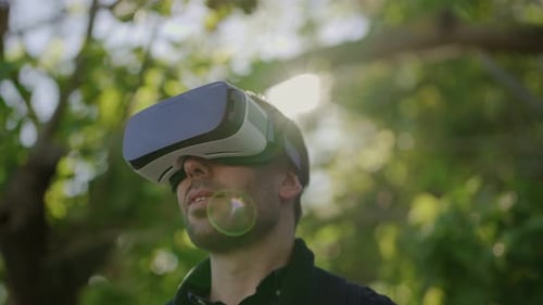 Smiling Man Using Virtual Reality Headset Outdoor