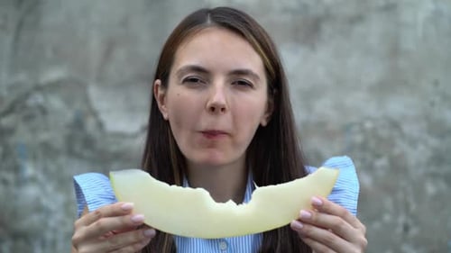 Portrait d'une belle jeune femme mangeant du melon