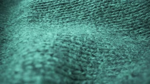 Extreme detail view of sheep wool cloth texture flowing in macro dolly shot.