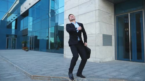 Young Happy Businessman in Suit Rejoices at Good Deal on City Street