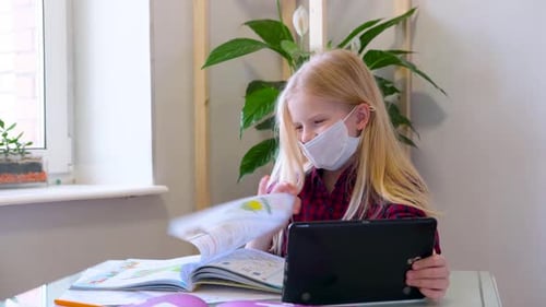Young Child Learning With Tablet and Medical Mask