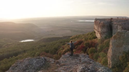 Person on Cliff Edge Enjoys Mountain View