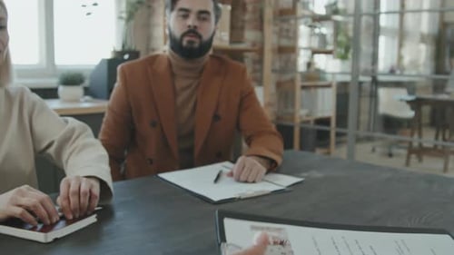 Interview Panel Reviewing Candidate Application in Office