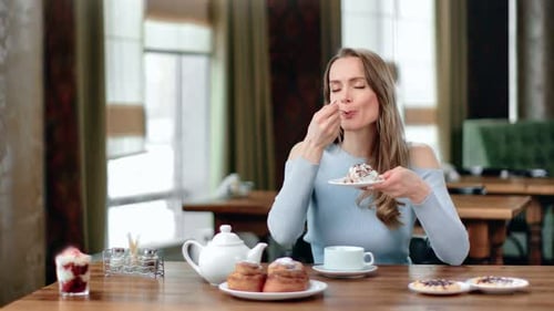 Portrait of Smiling Young Lady Eating Appetizing Pastry Dessert at Cafe