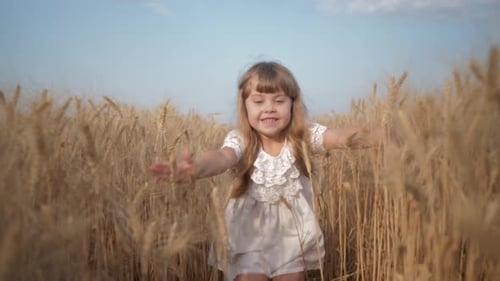 Wheat Yield Season, Happy Smiling Girl Runs Across Grain Field To Camera with Arms Outstretched To