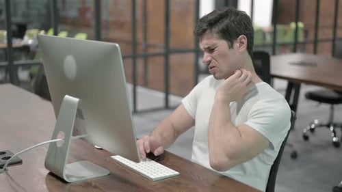 Young Man with Neck Pain at Work