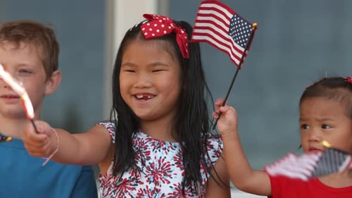 Children Waving American Flags and Sparklers
