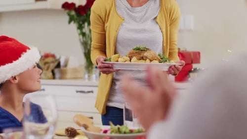 Woman Carries Roasted Chicken to Christmas Family Dinner