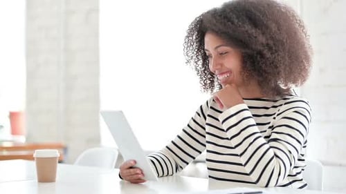 Woman Using Tablet for Video Call at Table