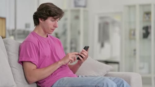 Young Adult Using Smartphone Celebrating Good News