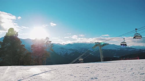 Winter Panorama with Ski Lifts and Snow Covered Mountains on a Sunny Day.