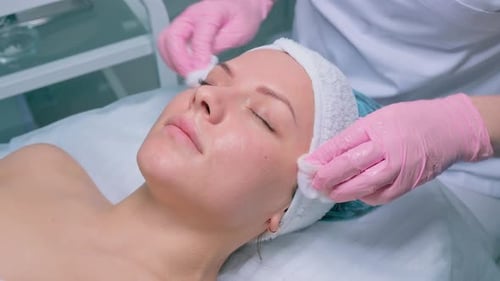 Woman Receiving Facial Treatment at Beauty Clinic