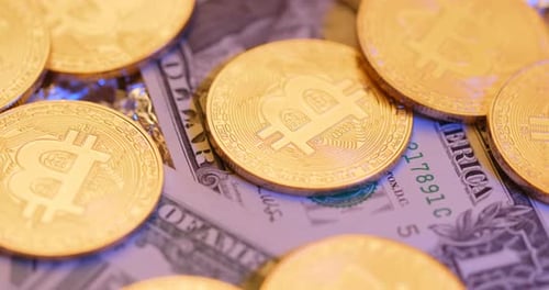 Gold Bitcoins Piled Atop US Dollar Bills