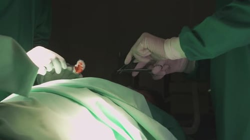 Group of team doctor and surgeon doing surgery with patient in the operation at hospital.