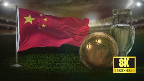 China Flag, Golden Soccer Ball, and Silver Trophy on Stadium Field
