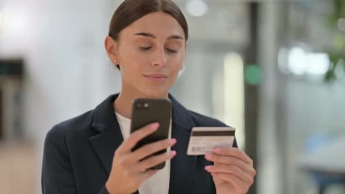 Smiling Woman Makes Online Payment With Credit Card