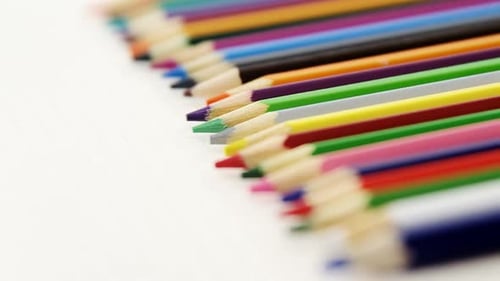 Bright Colored Pencils Lined Up on Paper